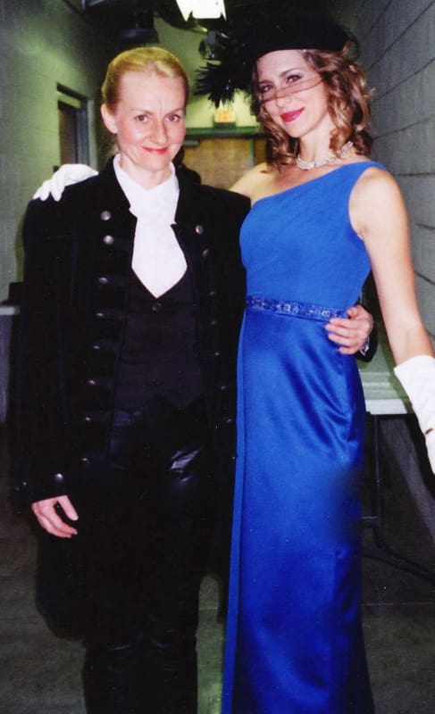 Two people dressed up in formal wear posing for a picture.